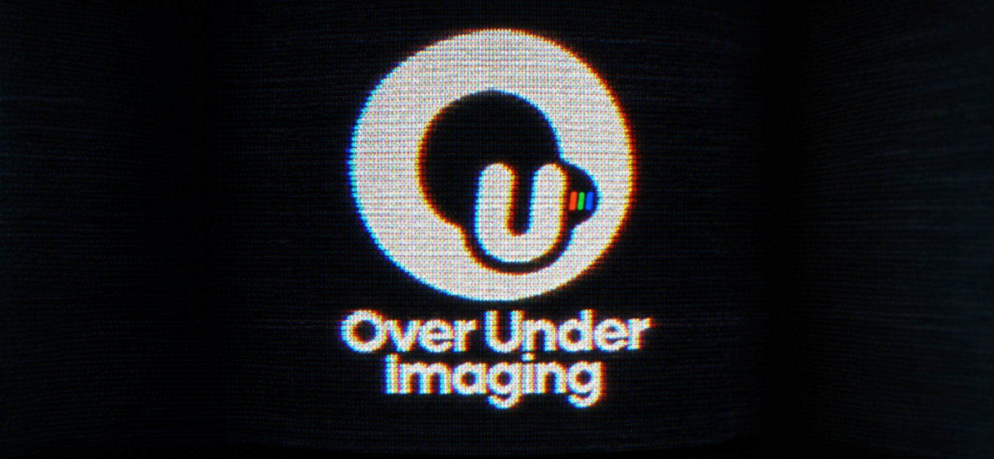 Over Under Imaging logo glowing on a CRT screen